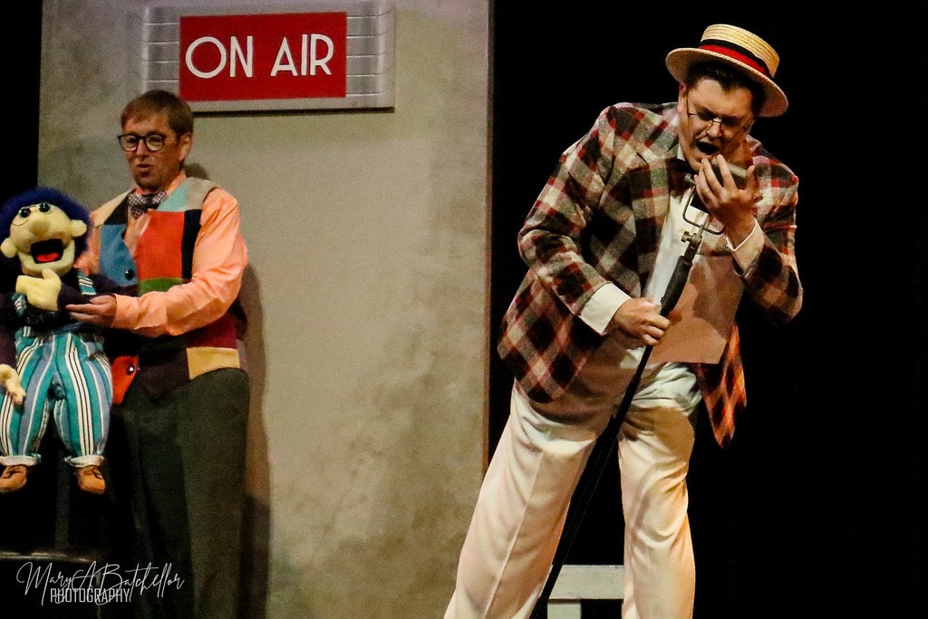 Annie — Bert Healy belts into a vintage microphone as the ventriloquist and his puppet look on