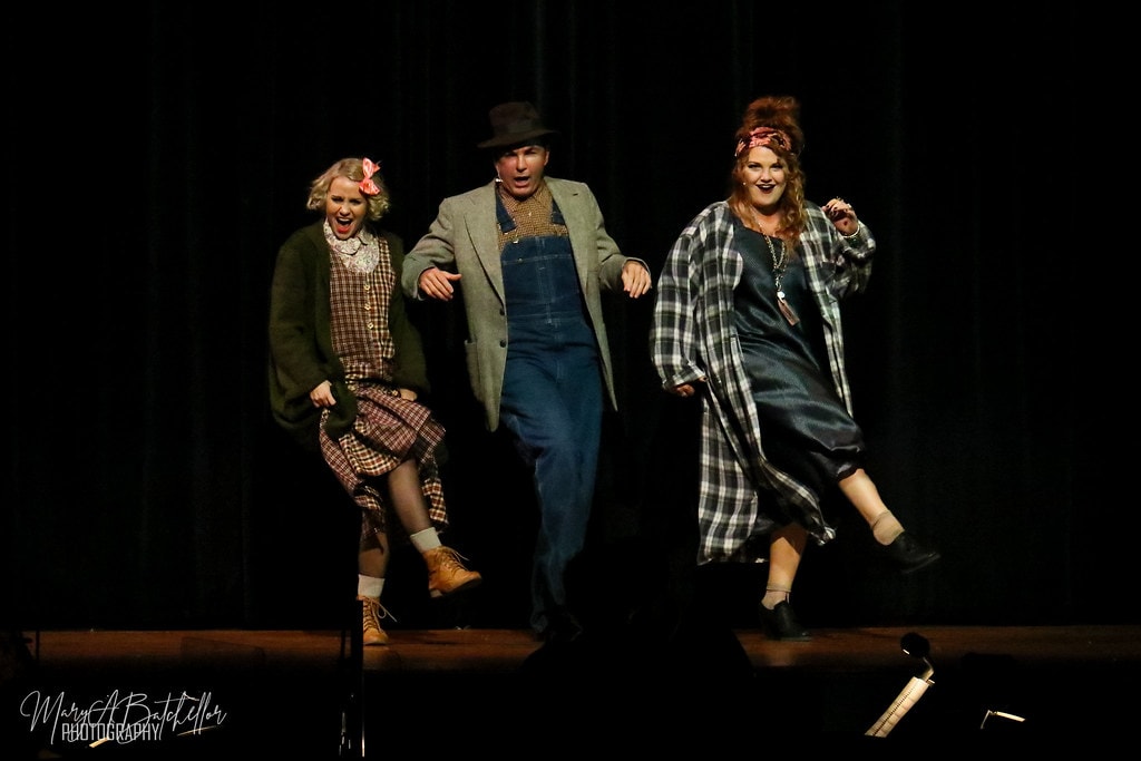 Annie — Lily St. Regis, Rooster, and Miss Hannigan dance together in a joyful trio on the dark stage