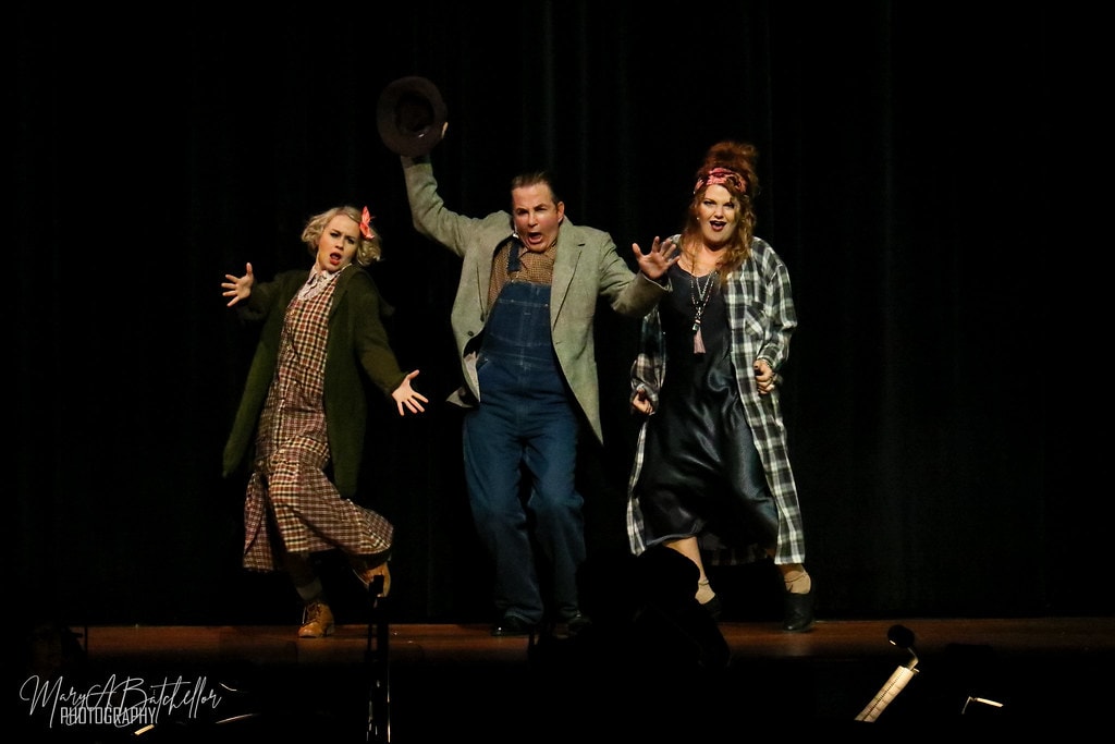Annie — Lily St. Regis, Rooster tossing his hat, and Miss Hannigan belt together with arms wide