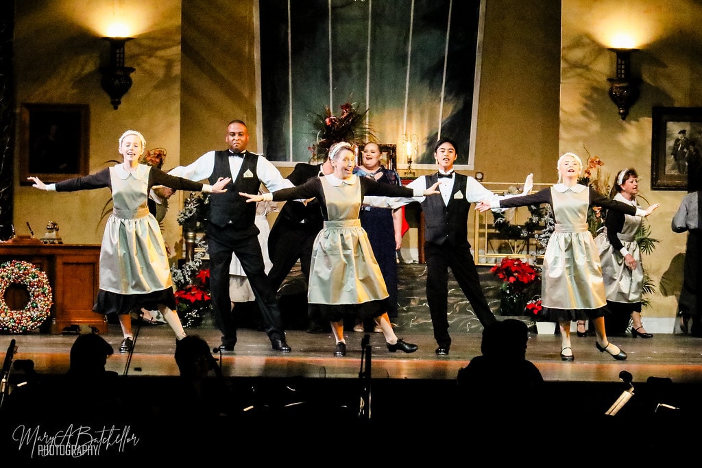 Annie — six Warbucks mansion servants stretch their arms wide in a synchronized dance pose