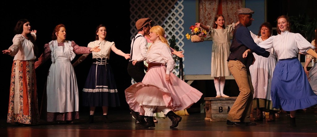Cast dancing and celebrating at the harbor — Carousel