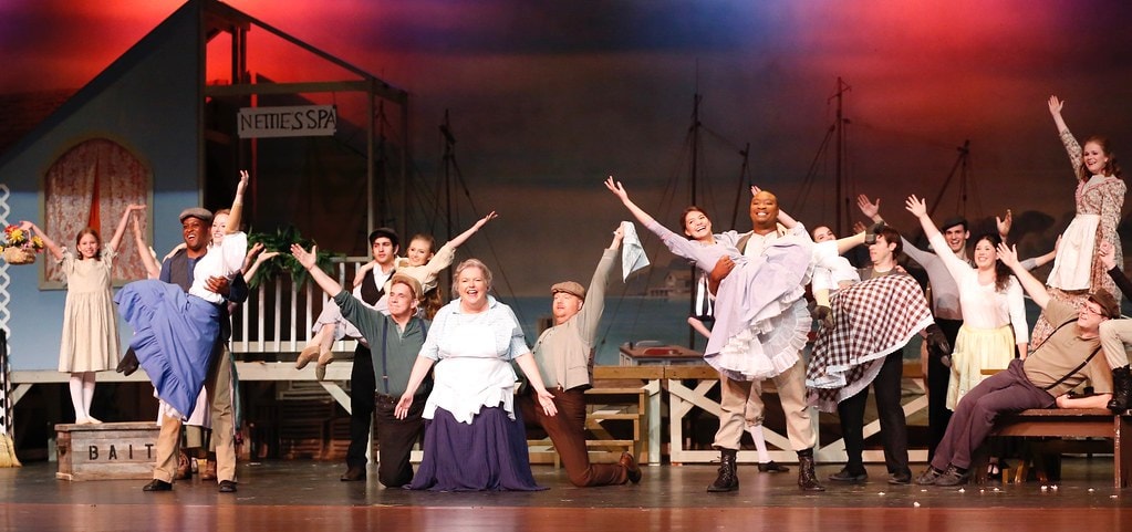 Full ensemble at Nettie's Spa with arms raised — Carousel