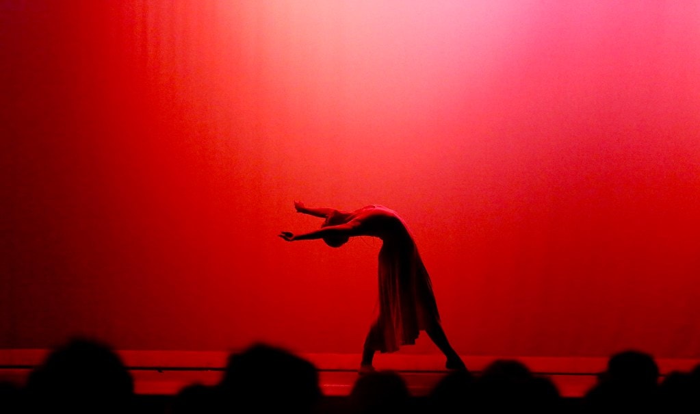Dancer silhouette against red light — Carousel