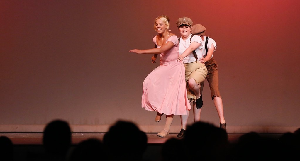 Julie dancing joyfully with young Enoch — Carousel