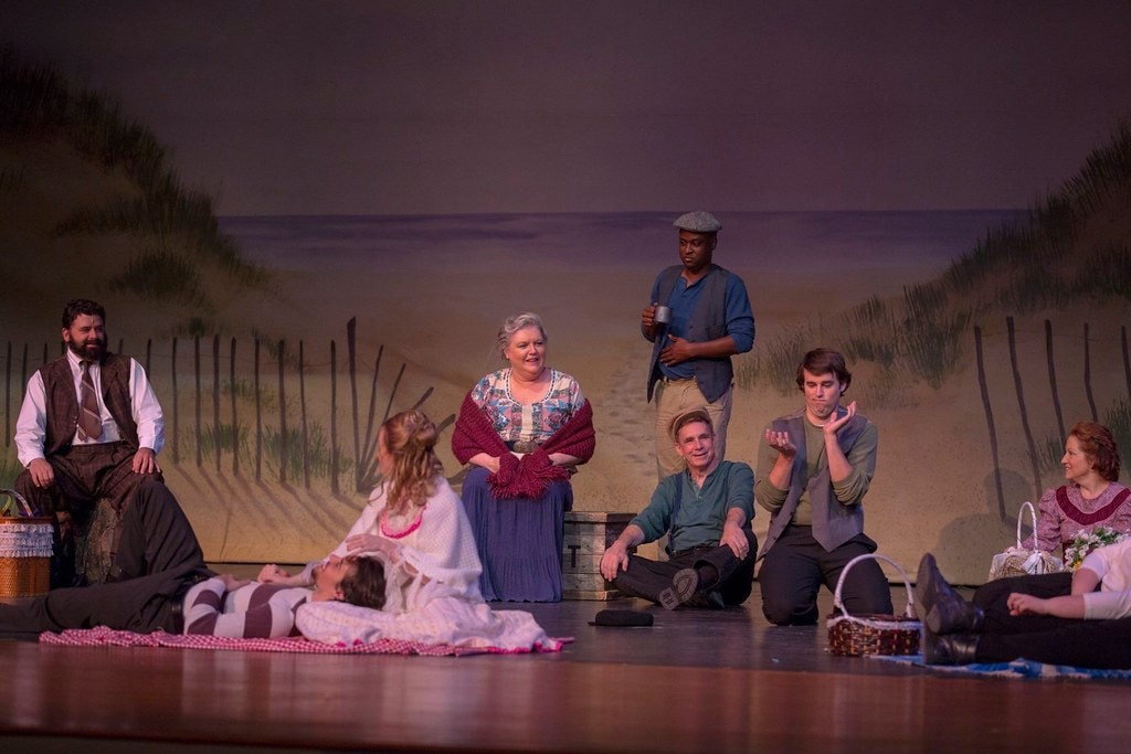 Intimate beach picnic group scene with Nettie and cast — Carousel