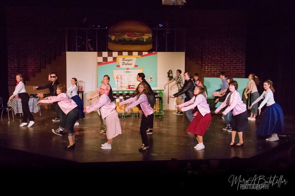 Grease — Pink Ladies and T-Birds performing at Burger Palace diner