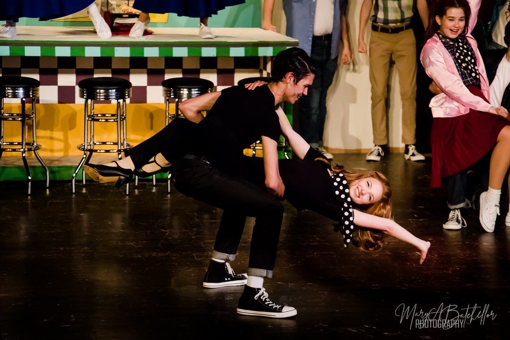 Grease — Danny dipping Sandy low during hand jive at the diner