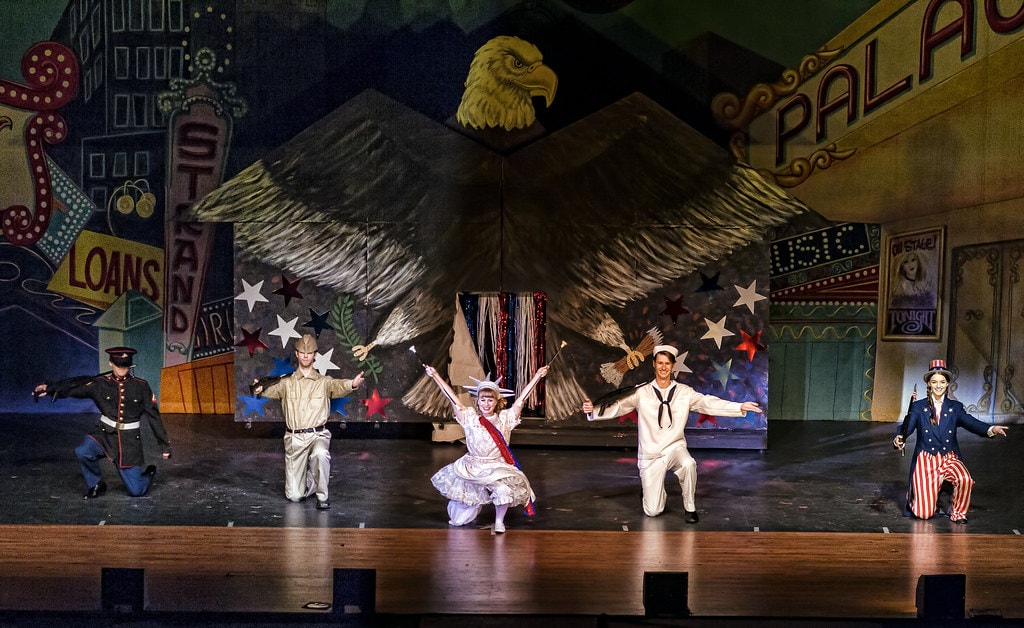 Gypsy — the same five patriotic performers take a wide bow before the full Broadway Palace backdrop with a giant painted eagle spreading its wings above the Loans and Stand marquee signs
