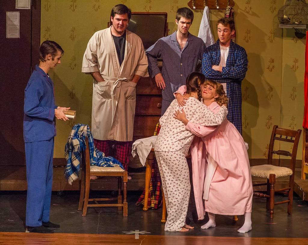 Gypsy — five performers in the boarding house set: a man in blue pajamas holds a book at left as three men in robes look on while two women in nightgowns embrace warmly at center