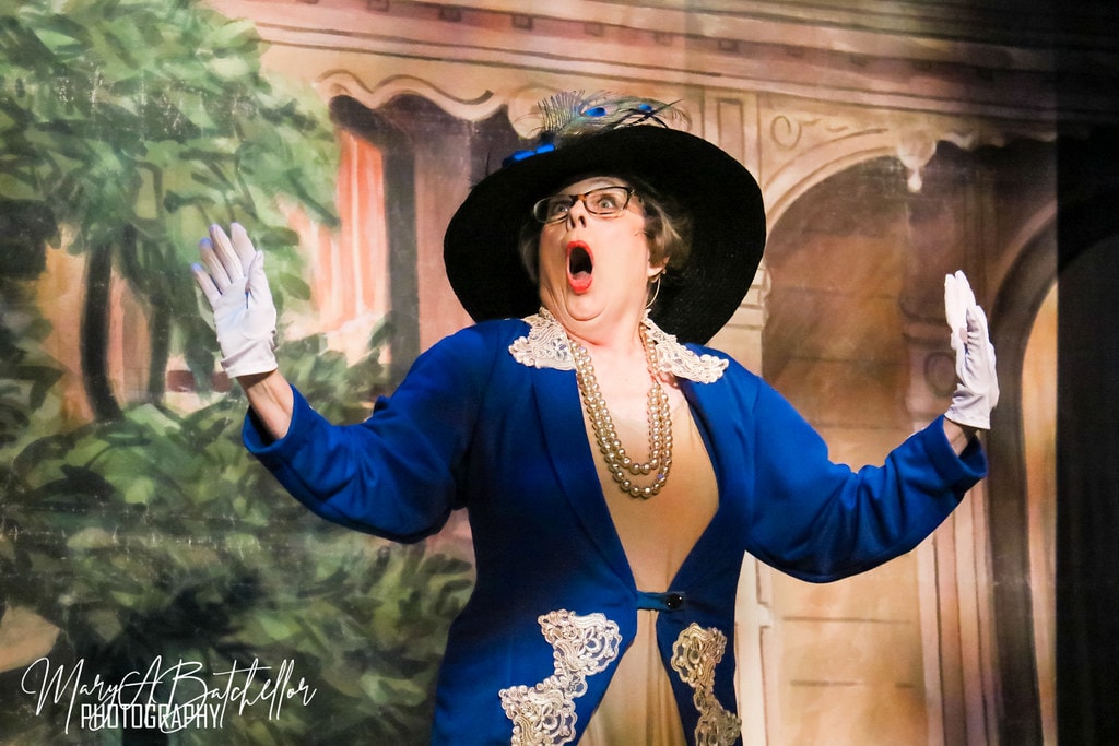 The Music Man — Eulalie Mackecknie Shinn in a blue peacock-feathered hat sings a dramatic solo
