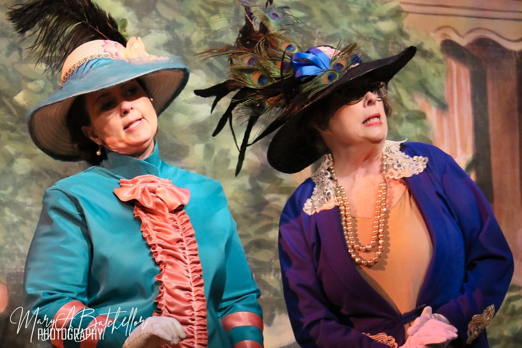 The Music Man — two River City ladies in elaborate Edwardian hats perform a comedic scene