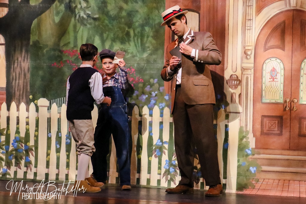 The Music Man — Harold Hill reads a card as two young boys look on