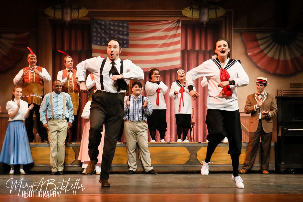 The Music Man — a man in suspenders and a woman in a sailor top dance energetically