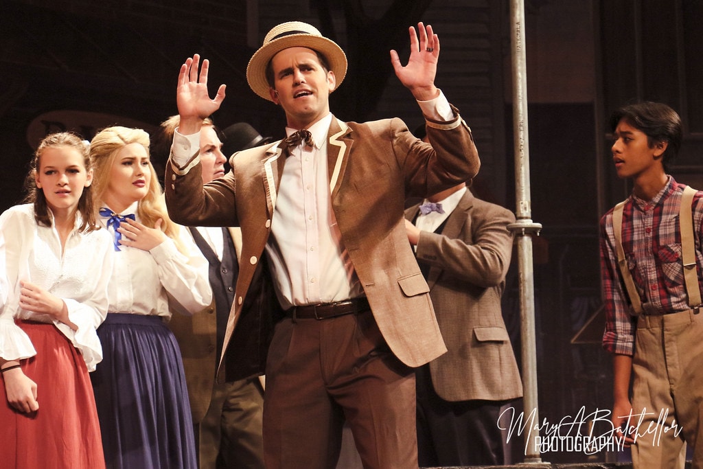 The Music Man — Harold Hill raises both hands to the crowd