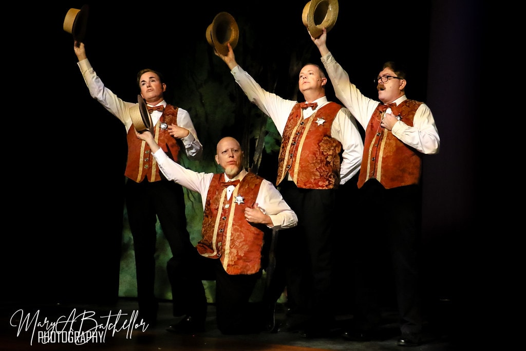 The Music Man — four men in period suits and straw boater hats perform a barbershop quartet
