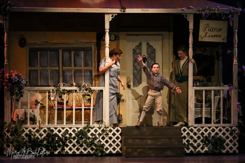 The Music Man — Mrs. Paroo and Marian react as young Winthrop leaps down the front steps