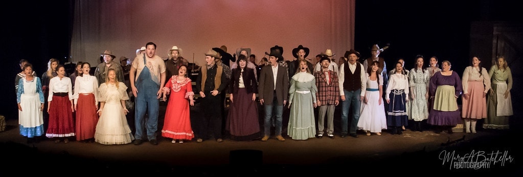 Oklahoma! — full cast singing with arms raised