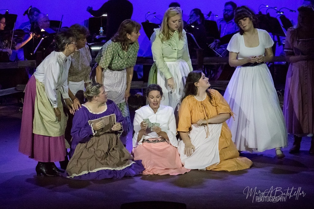 Oklahoma! — cast performing under purple stage lights
