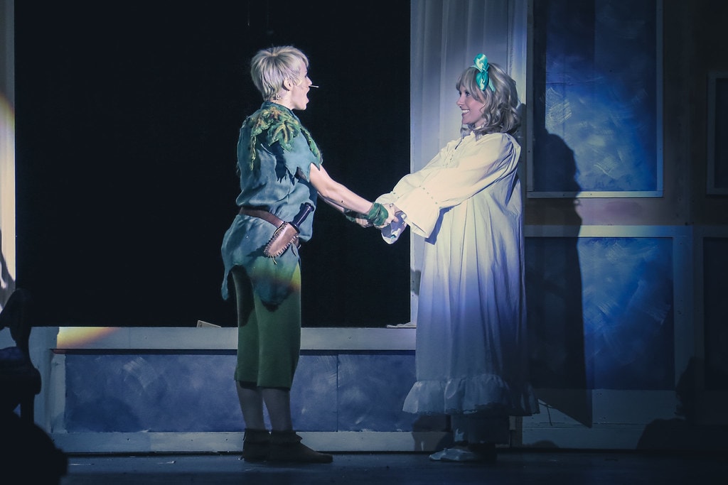 Peter Pan — Peter Pan and Jane hold hands in the blue-lit nursery window scene