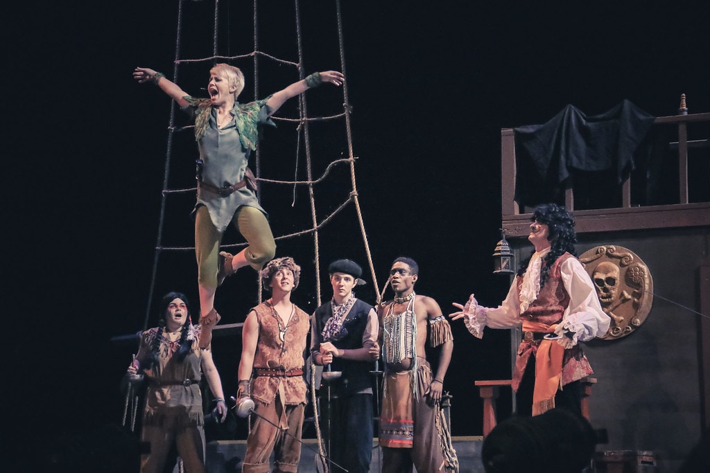 Peter Pan — Peter Pan stands triumphant on the ship rigging above the Lost Boys and Captain Hook
