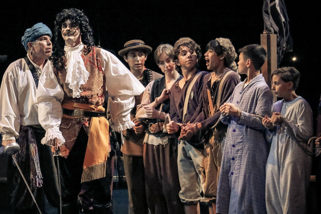 Peter Pan — Captain Hook and Mr. Smee face the Lost Boys and the Darling children tied with rope on the ship deck