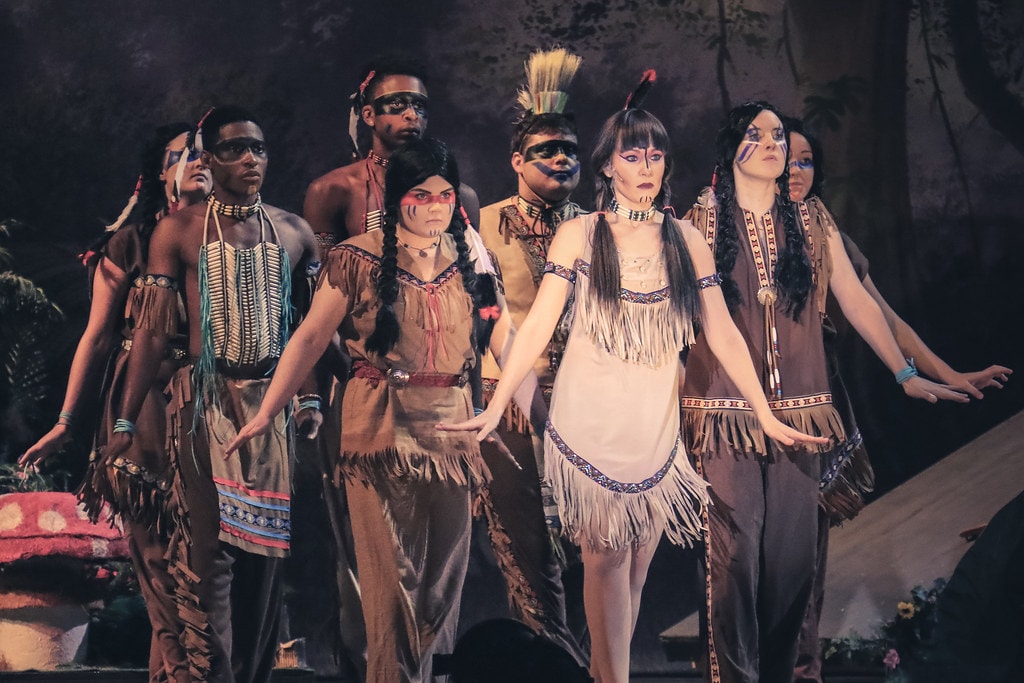 Peter Pan — Tiger Lily and her tribe in full Native American costumes before the Neverland jungle backdrop