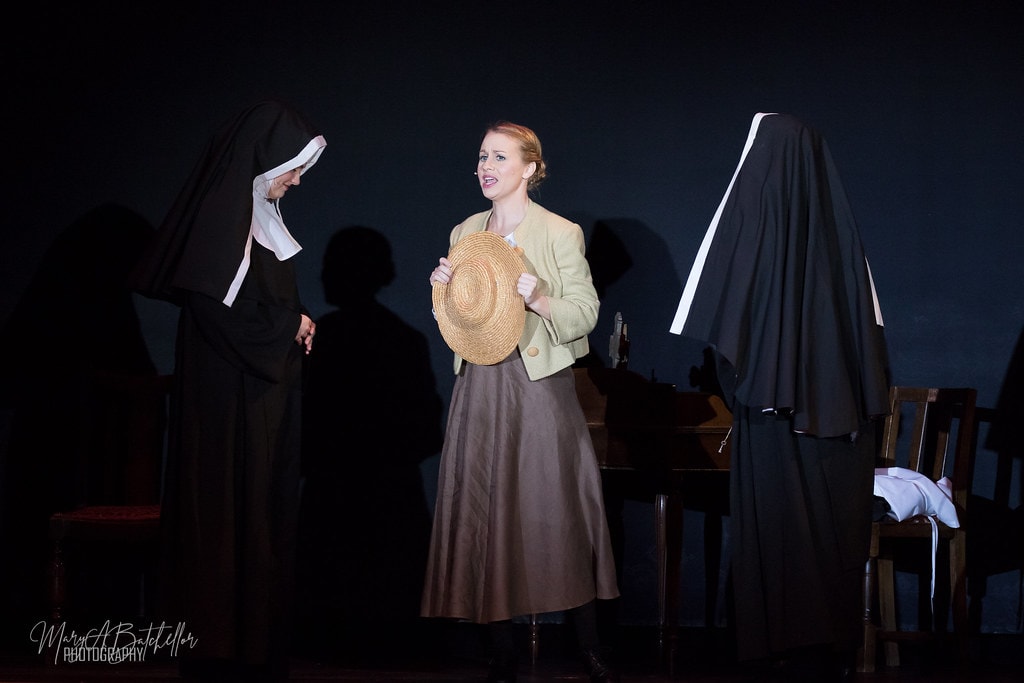The Sound of Music — Maria holding her straw hat speaking with a nun