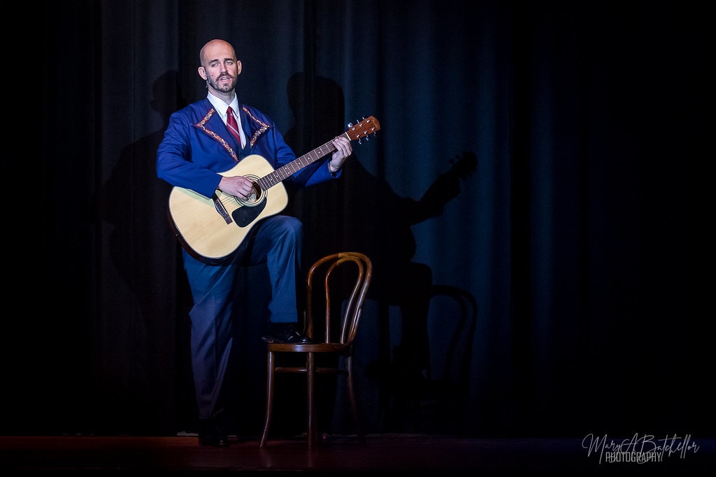 The Sound of Music — Captain von Trapp playing acoustic guitar in dramatic spotlight