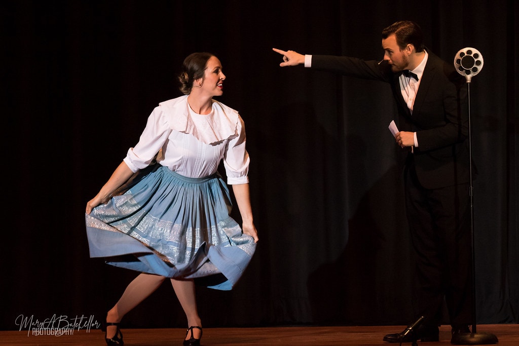 The Sound of Music — Max Detweiler pointing at Maria who twirls her blue skirt