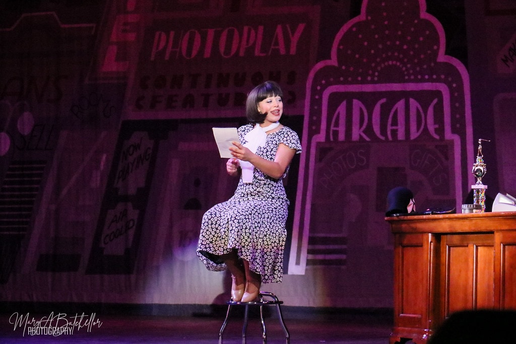 Thoroughly Modern Millie — Millie sings a solo before the Art Deco arcade backdrop