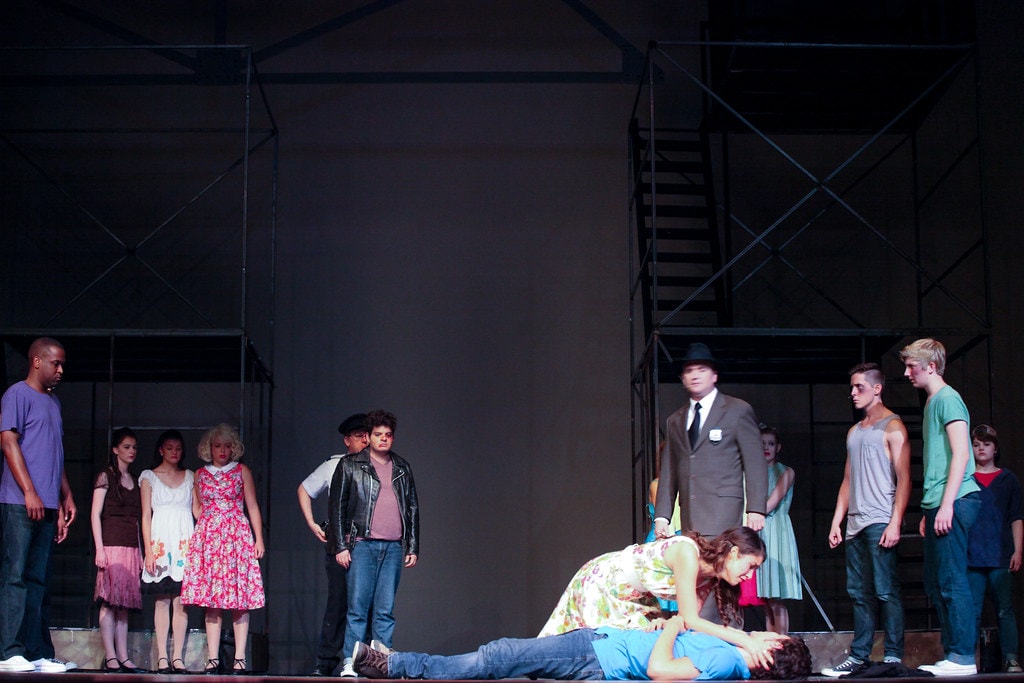 Cast gathered around fallen performer — West Side Story